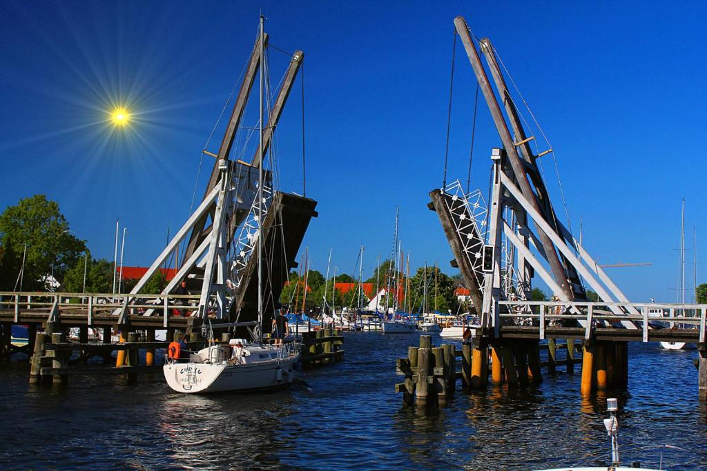 a boat is docked at a dock in the water at Hanse Haus Pension in Greifswald