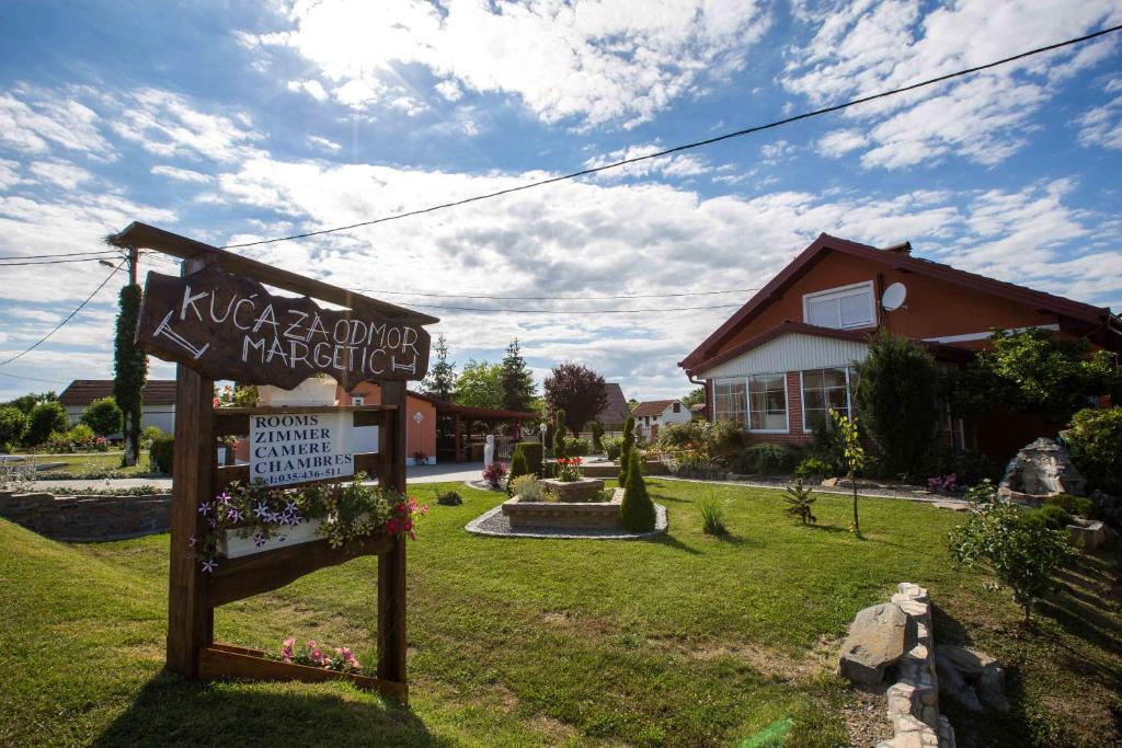 a sign in a yard in front of a house at Apartments Margetic in Živike