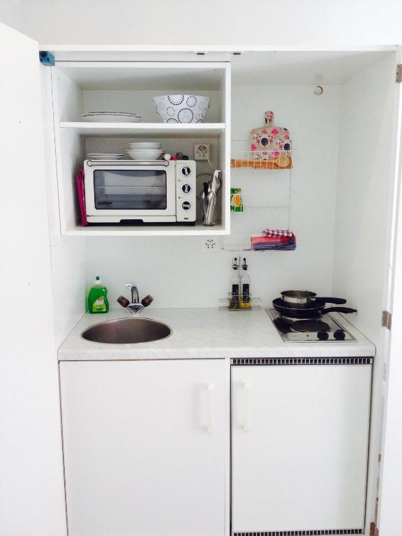 a small kitchen with a sink and a microwave at Bed and Breakfast 57 in Asuel