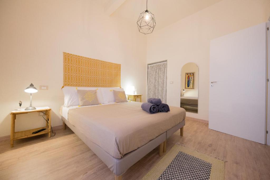 a bedroom with a large bed with a large headboard at B&B In Acquaviva in Livorno