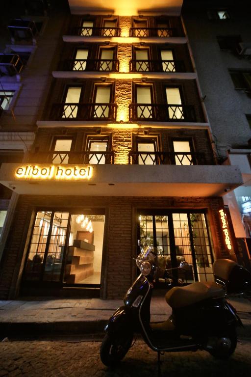 a scooter parked in front of a building at night at Elibol Hotel Old City in Istanbul