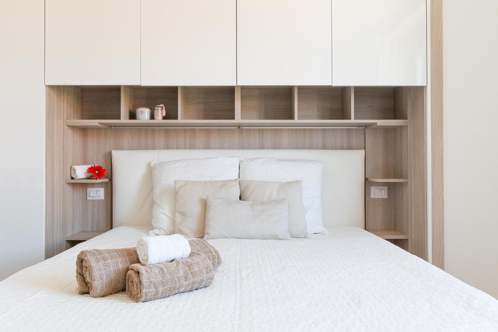 ミラノにあるAlessia's Flat - Sarpi 2の白いベッド1台(白いキャビネット付)が備わるベッドルーム1室が備わります。