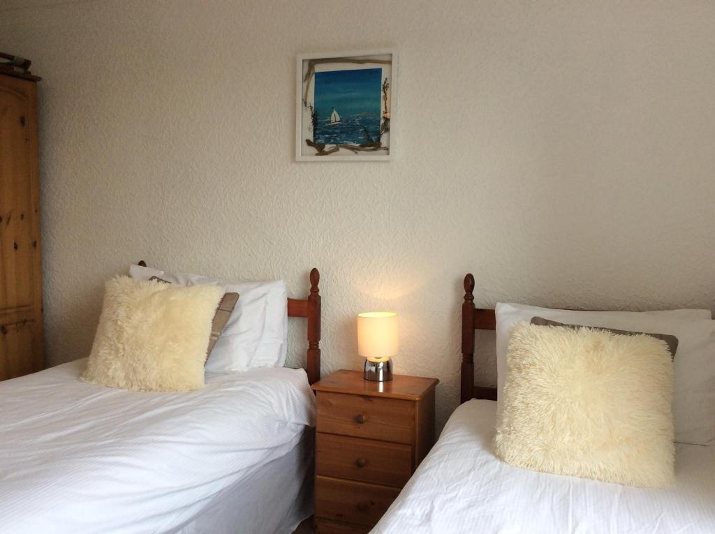 Postel nebo postele na pokoji v ubytování Ashbank Hotel