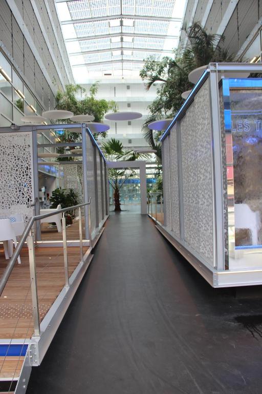 a hallway in a building with plants on the walls at Les Thermes in Dax