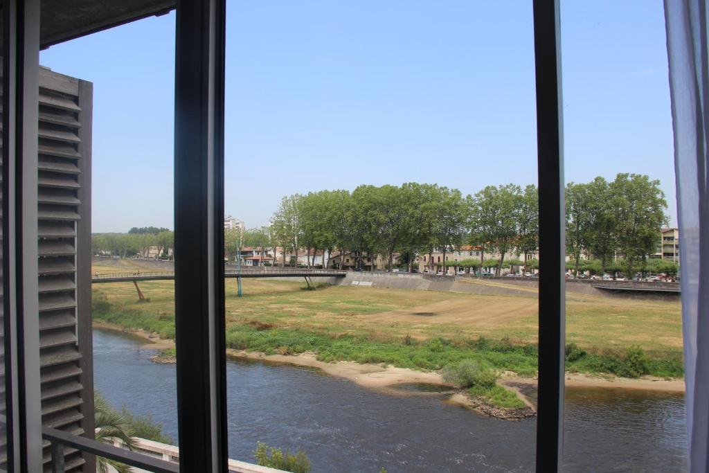 a view of a river from a window at Les Thermes in Dax