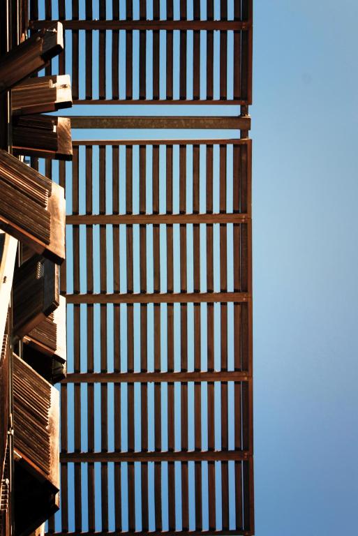 a stack of wooden fences against a blue sky at Les Thermes in Dax