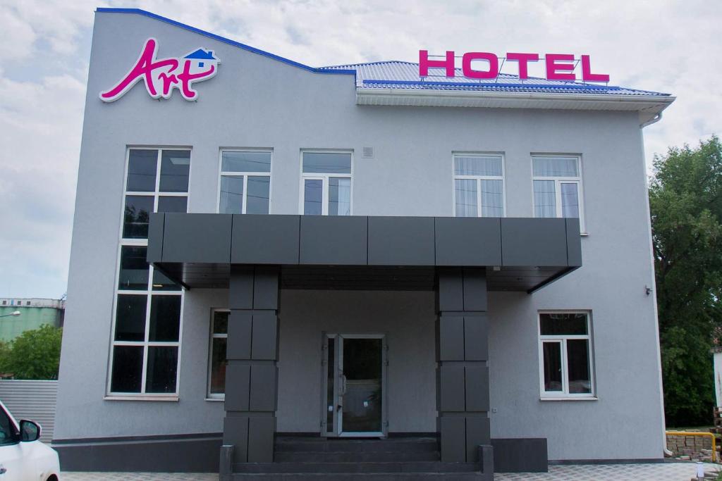 a building with a sign on the front of it at Art Hotel in Tikhoretsk