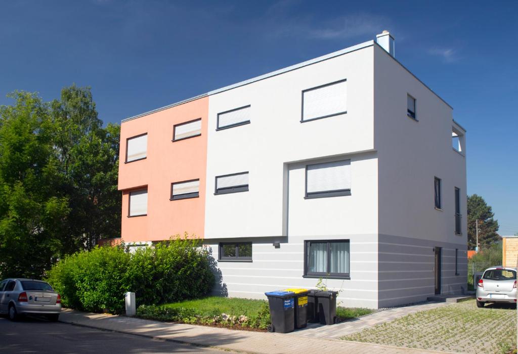 un grande edificio bianco con macchine parcheggiate di fronte di Bei Meyers - Leipzig Herzklinik a Lipsia