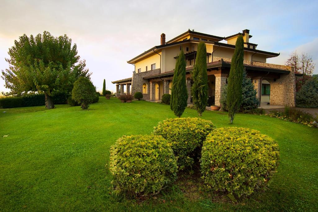 a large house with bushes in the yard at Radici Resort in Mirabella Eclano