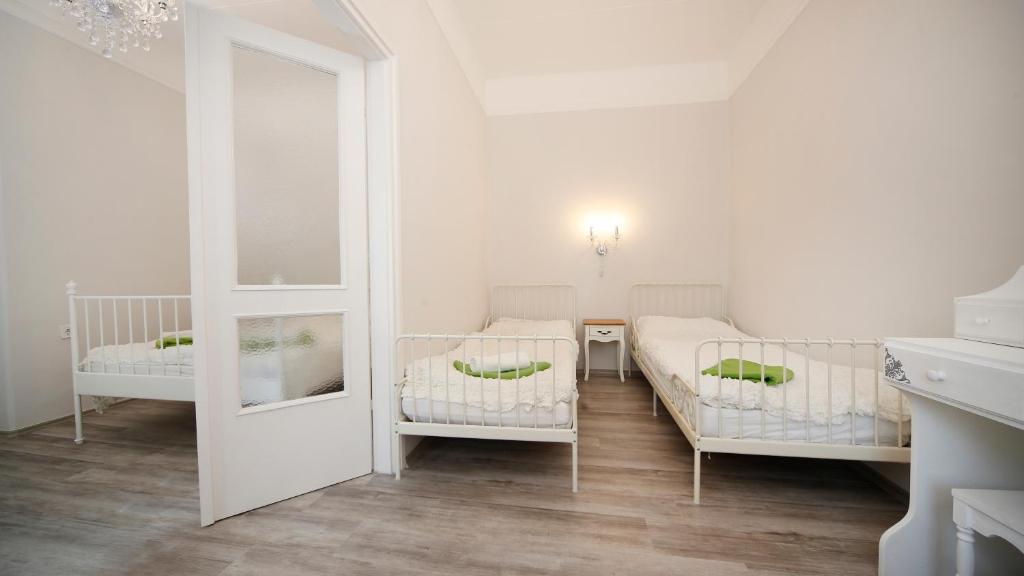 A bed or beds in a room at Öreg Malom Apartmanház