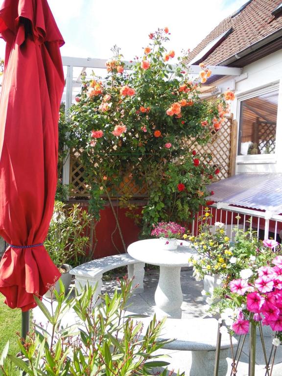 a patio with a white table and a bunch of flowers at Ferienwohnung Müller Bad Segeberg in Bad Segeberg