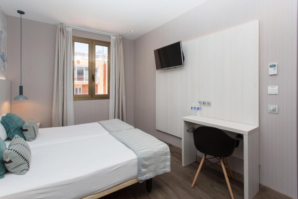 Posteľ alebo postele v izbe v ubytovaní Hostal Operaramblas