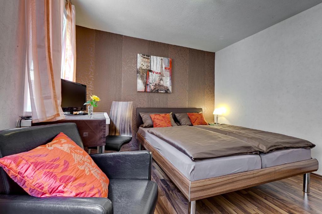 ein Schlafzimmer mit einem Bett und einer Couch in der Unterkunft Hotel Alte Post in Calw