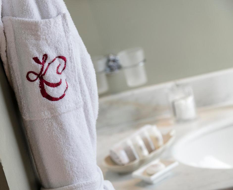 a towel on a bathroom counter with a sink at Le Cavendish in Cannes