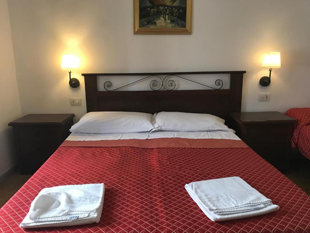 a bedroom with a bed with two towels on it at Vertex Suite in Rome