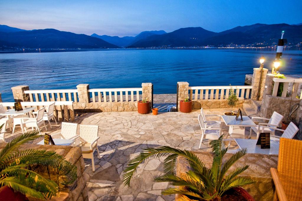 a patio with chairs and a view of the water at Luxury Sea Residence by Kristina in Tivat