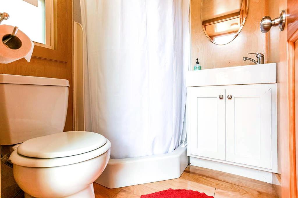 ein Badezimmer mit einer weißen Toilette und einem Waschbecken in der Unterkunft Tiny House in Austin