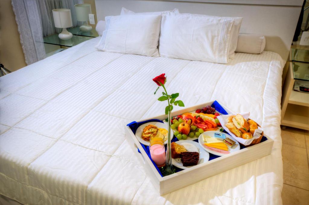 a tray of food on top of a bed at Hotel Jangadeiro in Recife