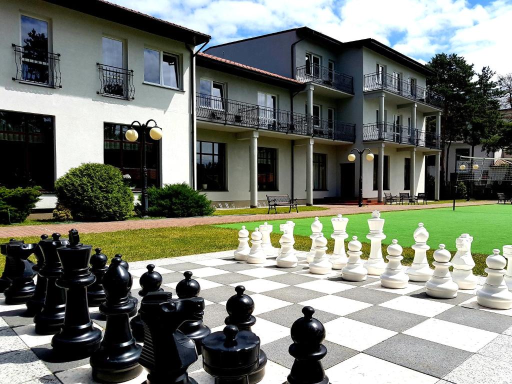 a chess board on the lawn in front of a building at Ośrodek Wczasowy Marevita in Dziwnówek