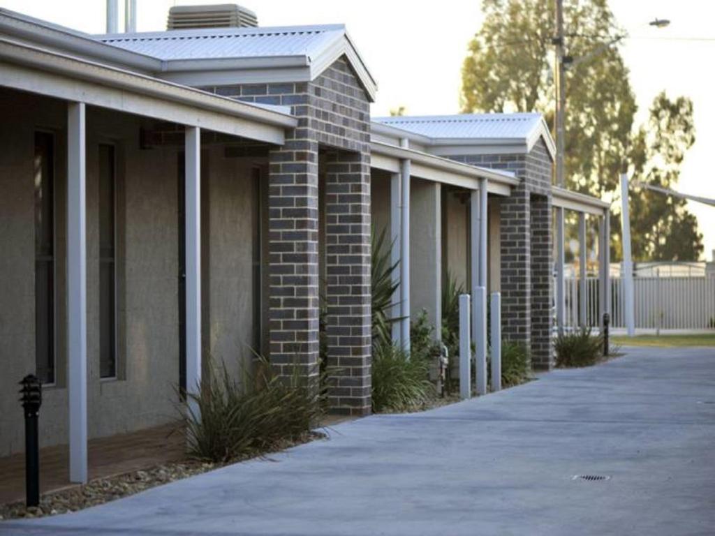a row of brick buildings with a driveway at Kennedy Holiday Villas in Mulwala
