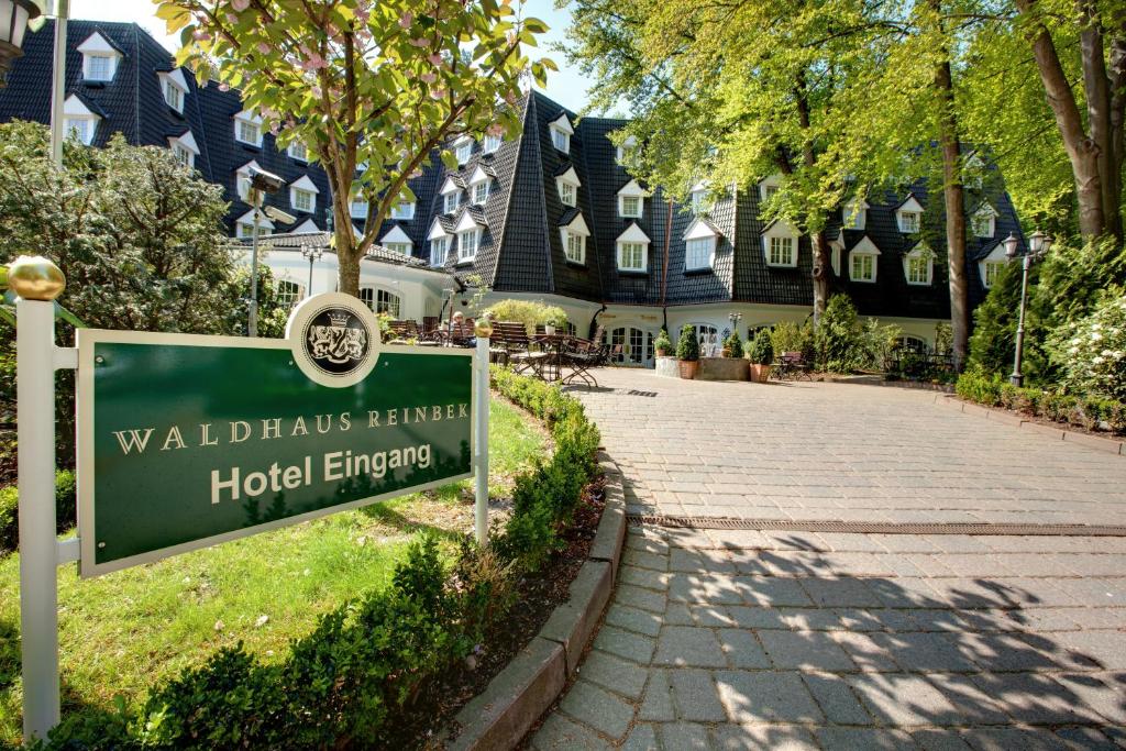 a sign in front of a building with a street at Waldhaus Reinbek in Reinbek