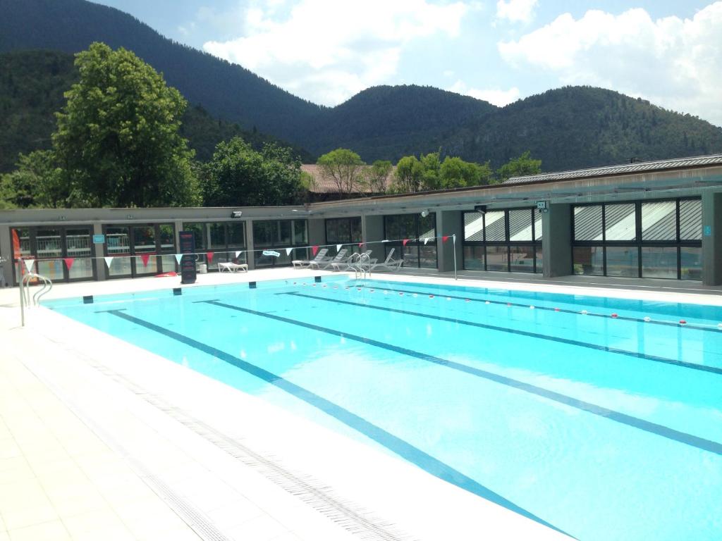 a large swimming pool with mountains in the background at In the heart of nature in Valdeblore