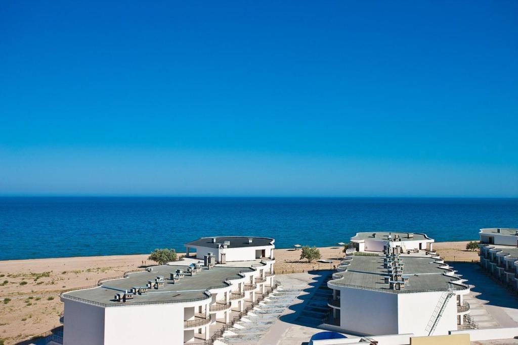 a row of buildings on the beach near the ocean at Apartment near the sea in Gribovka