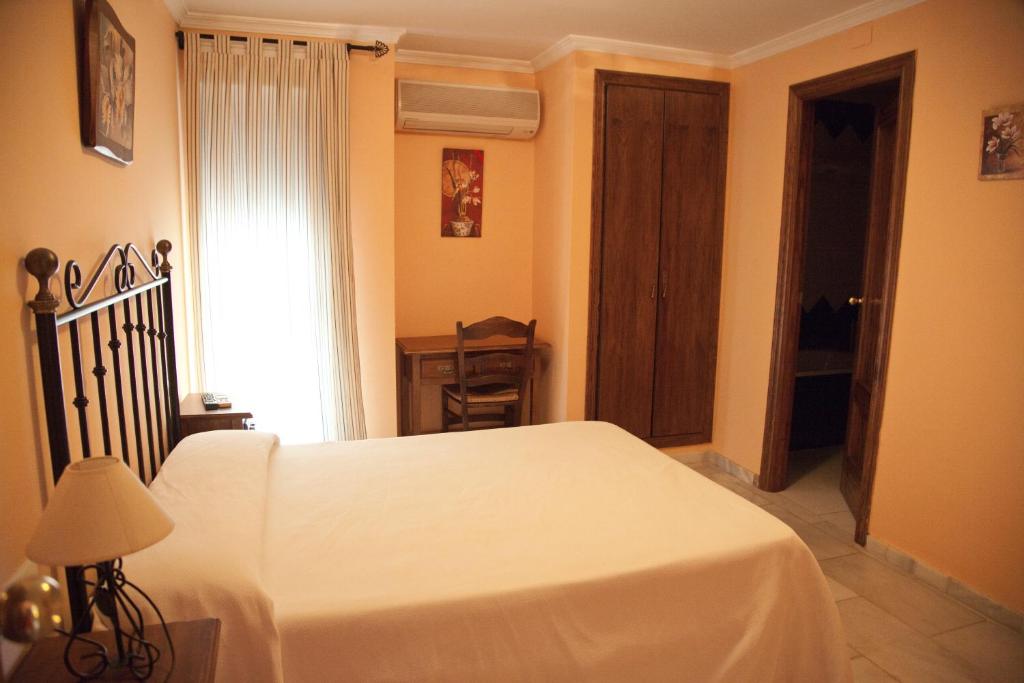 Posteľ alebo postele v izbe v ubytovaní Hostal Niza