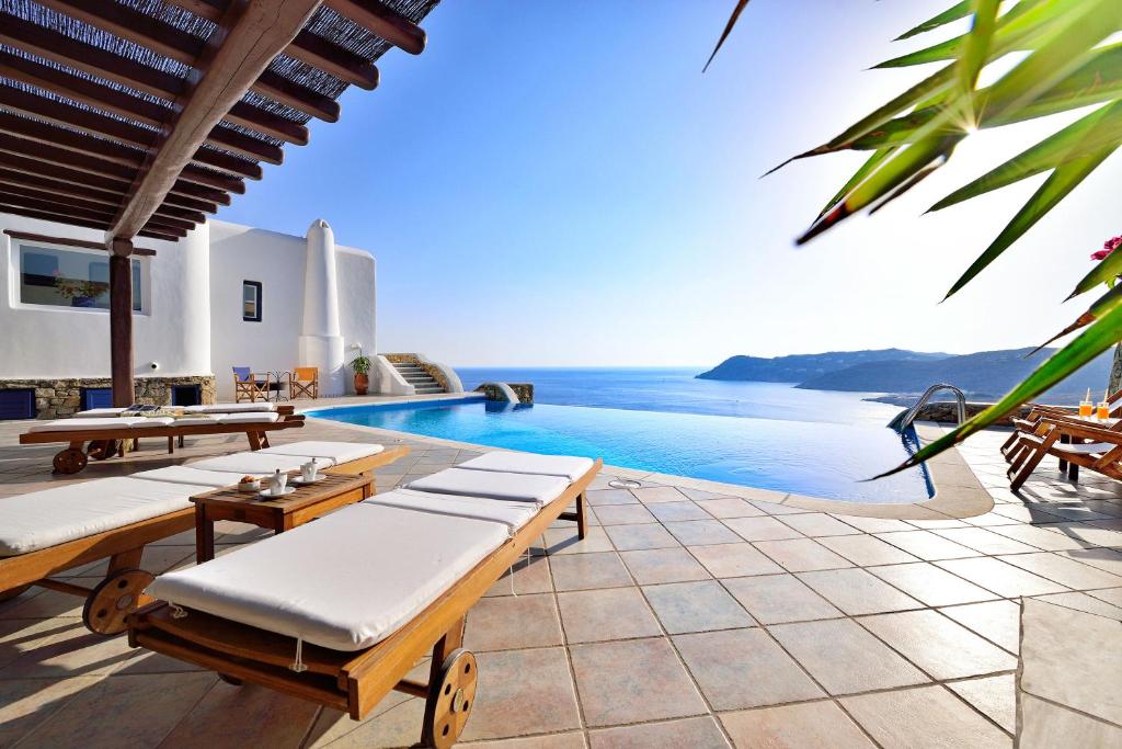 a villa with a pool and a view of the ocean at Mykonian Dianthus in Elia Beach