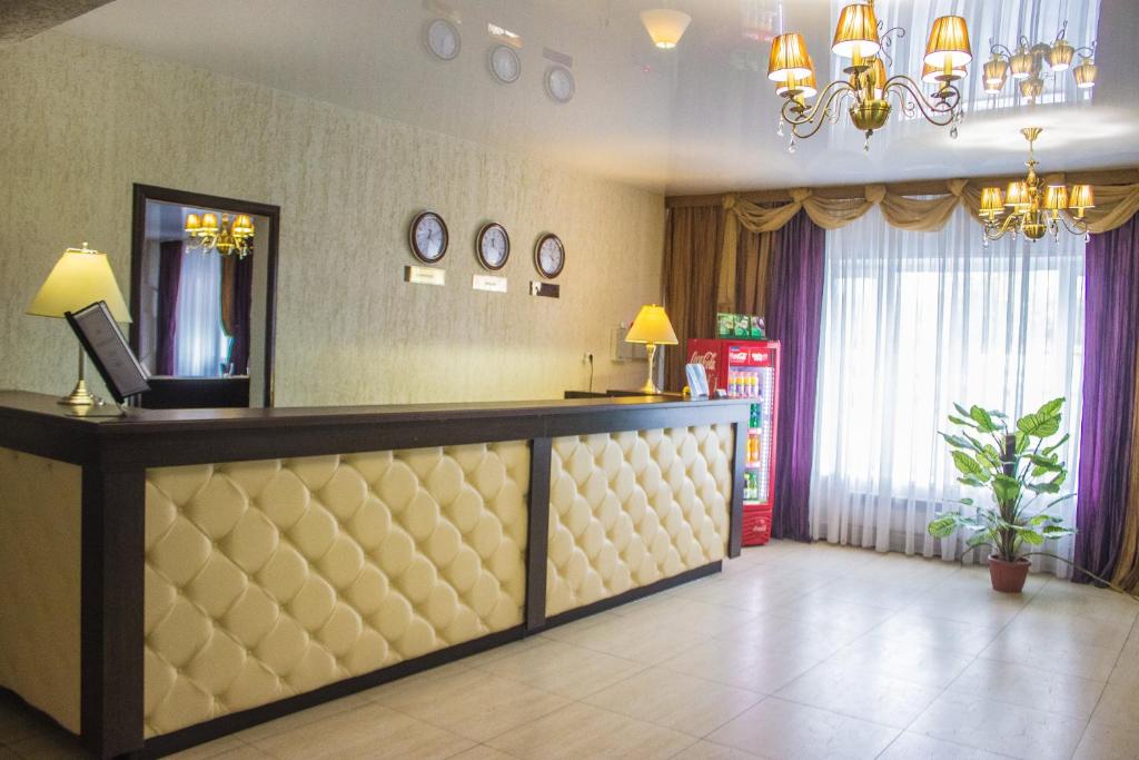 a hotel lobby with a reception desk and a mirror at Hotel Best-Zuro in Ulyanovsk