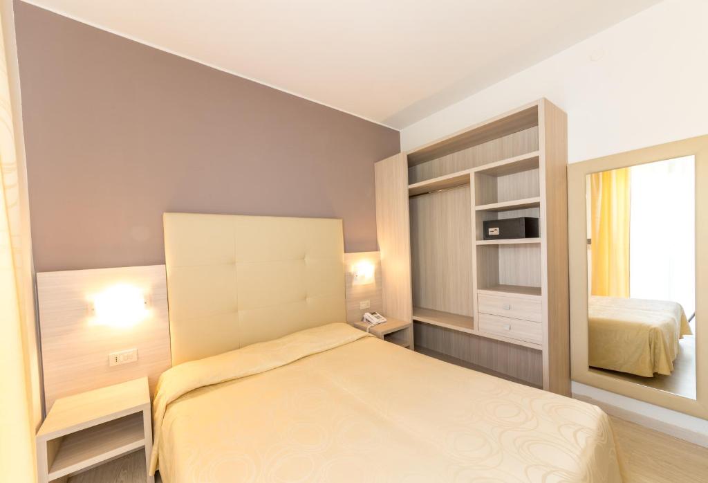 Postel nebo postele na pokoji v ubytování Hotel Torino