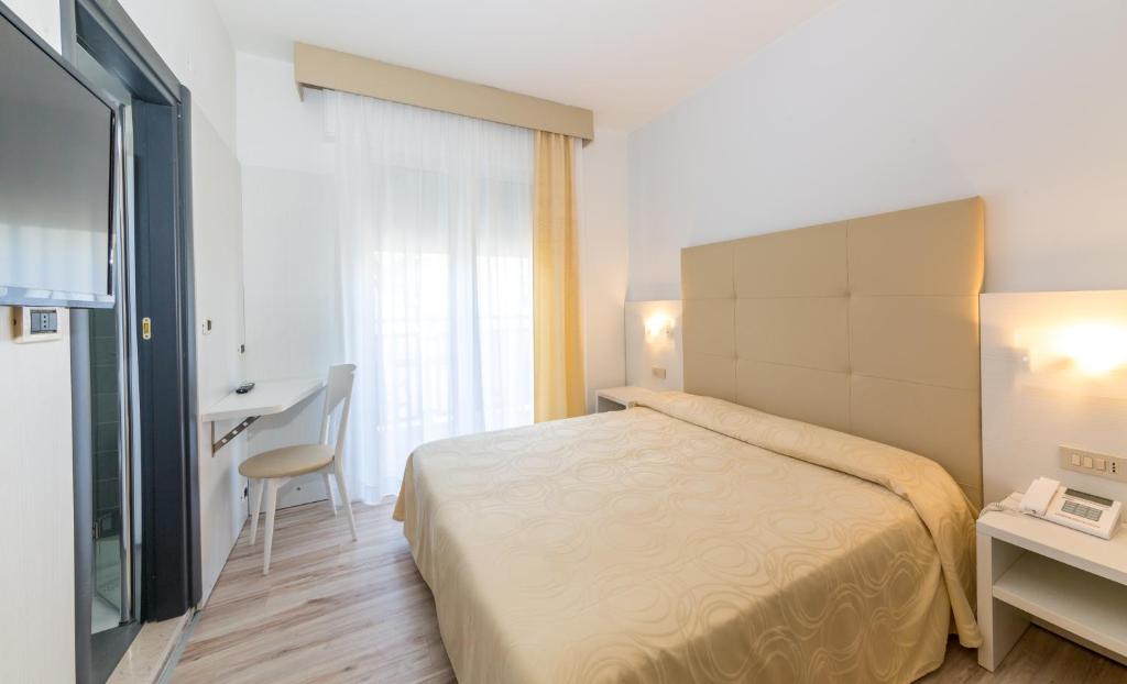 Postel nebo postele na pokoji v ubytování Hotel Torino