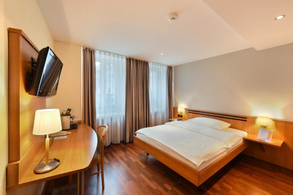 Postel nebo postele na pokoji v ubytování Apart Hotel Amadeo