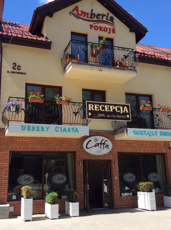 a building with signs on the side of it at Amberia Mikołajki in Mikołajki