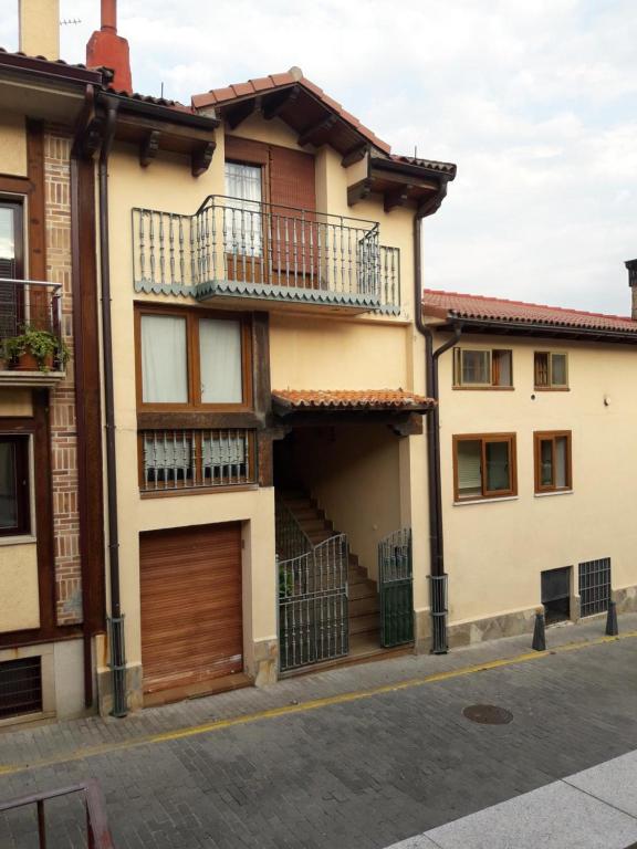 an apartment building with a garage and a building at Arcalís in Rascafría