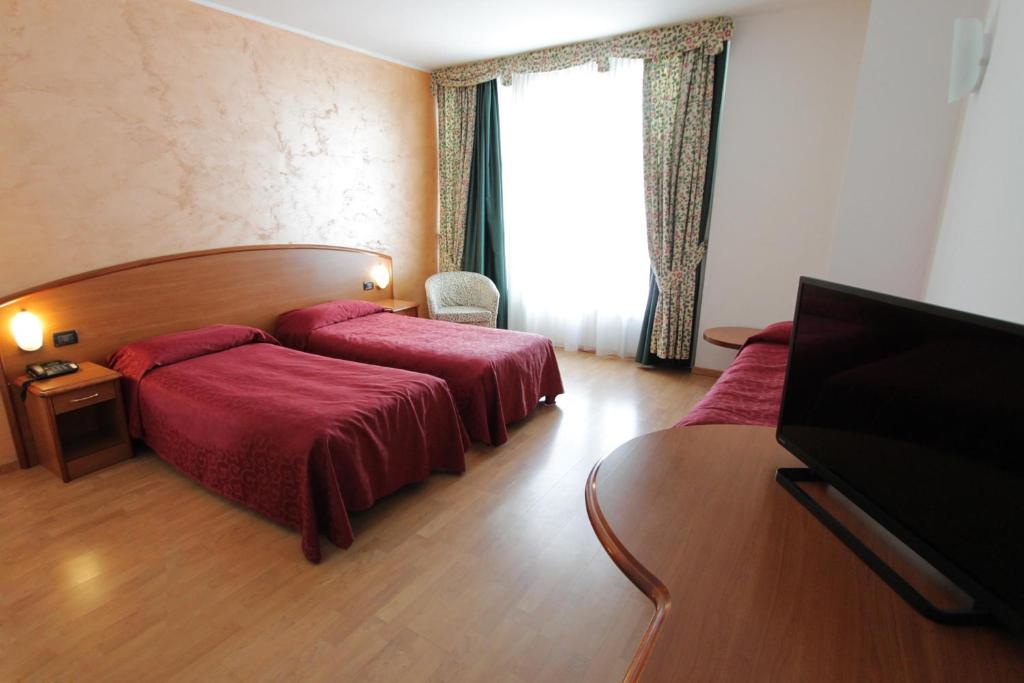 Postel nebo postele na pokoji v ubytování Hotel Europa