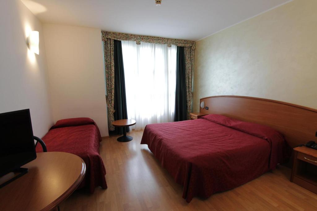 Postel nebo postele na pokoji v ubytování Hotel Europa