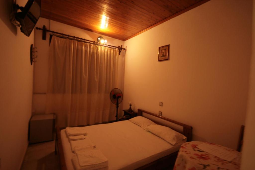 A bed or beds in a room at Chania Rooms