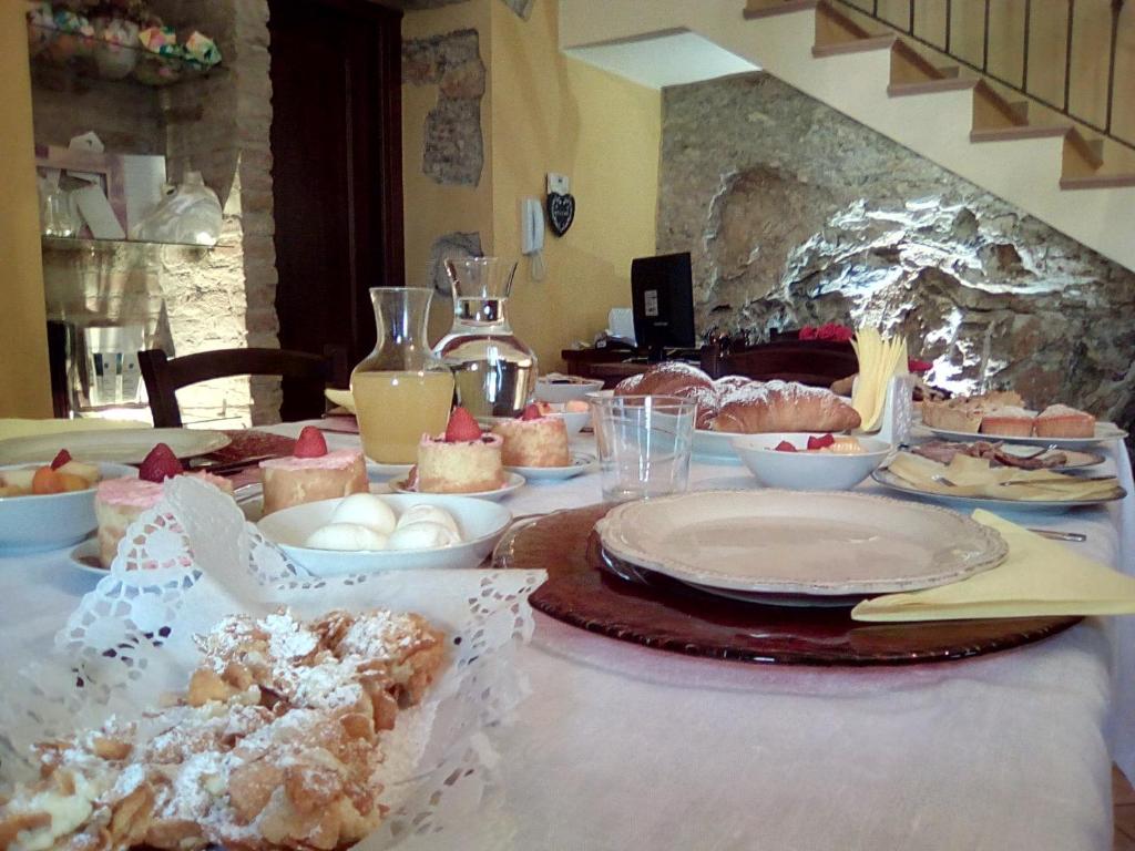 une table recouverte de assiettes et de bols de nourriture dans l'établissement Bed and breakfast La Sentinella, à Civita