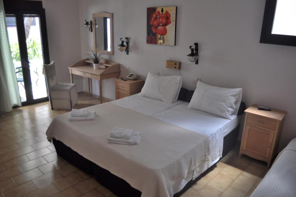Postel nebo postele na pokoji v ubytování Byzance Hotel