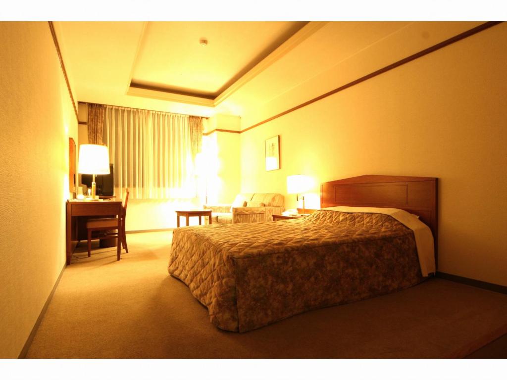 Postel nebo postele na pokoji v ubytování Hotel Danrokan