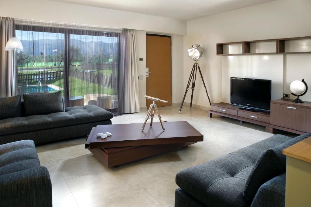a living room with a couch and a coffee table at Elite City Resort in Kalamata