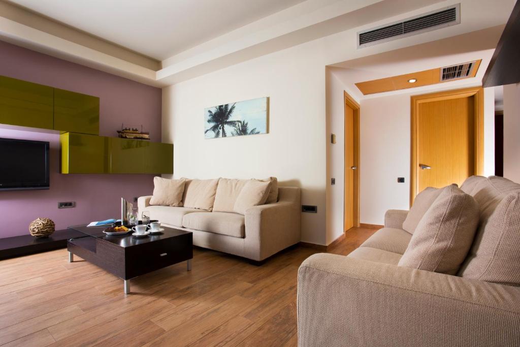 a living room with a couch and a table at Elite City Resort in Kalamata