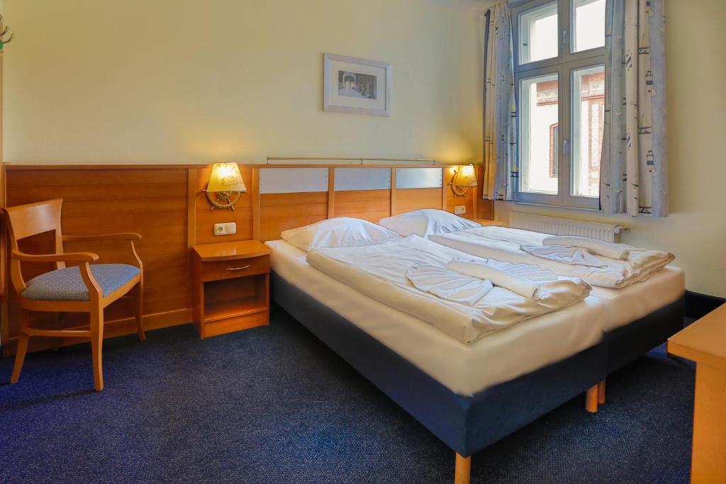Postel nebo postele na pokoji v ubytování Hiddenseer Hotel