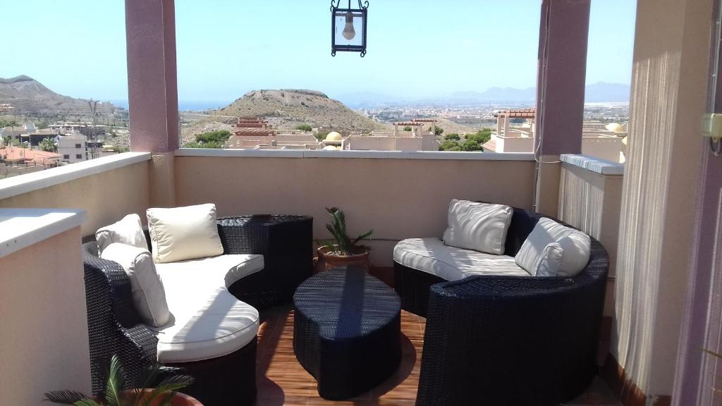a balcony with chairs and a view of the mountains at Apartamento Relax in Águilas