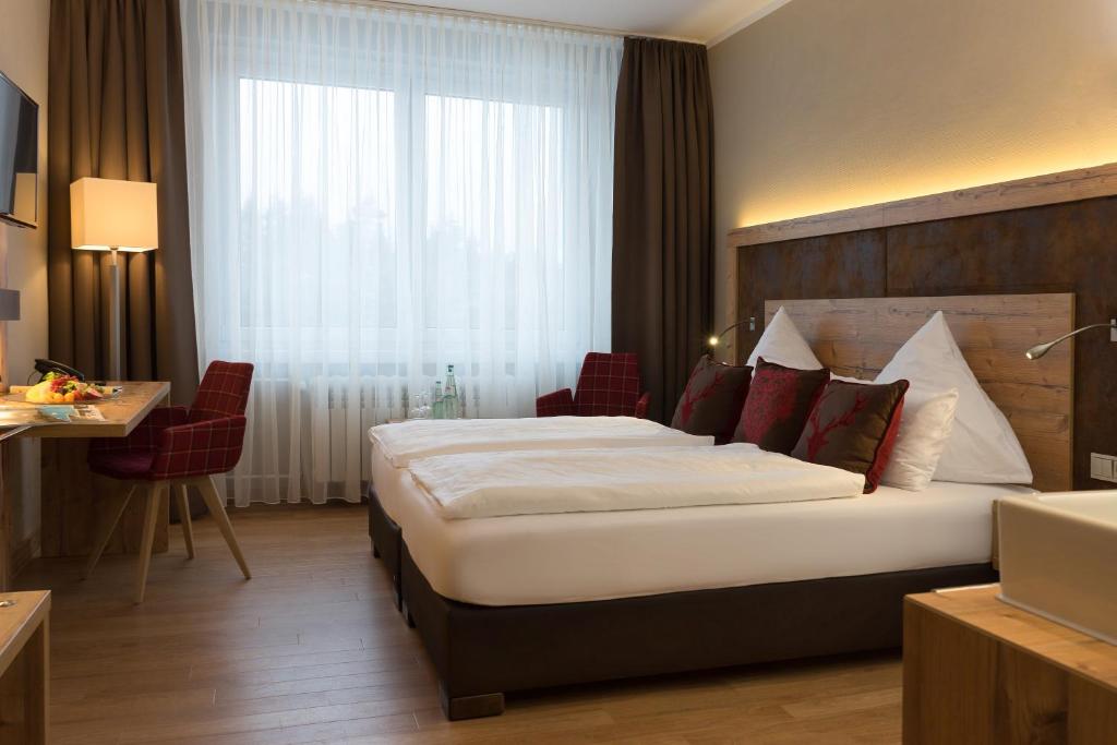 Postel nebo postele na pokoji v ubytování Waldhotel Berghof