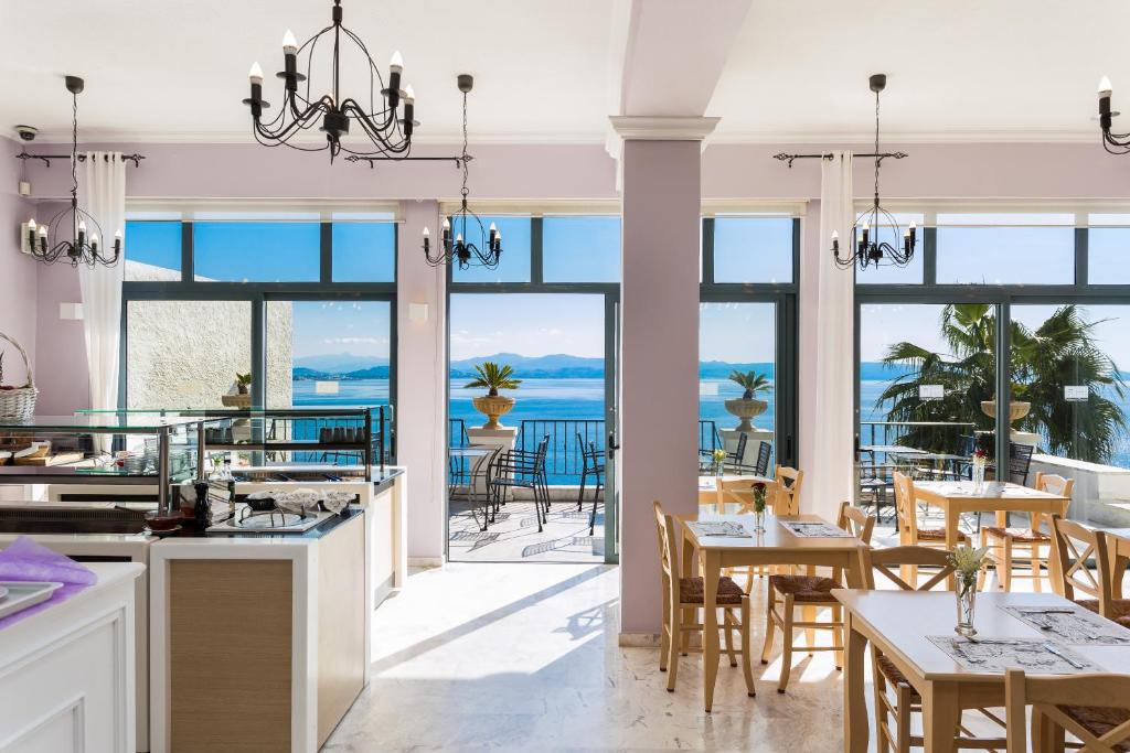 a kitchen and dining room with a view of the ocean at Palazzo Greco in Agia Galini