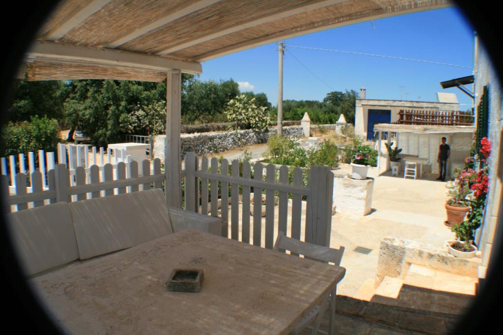 a view of a patio with a table and a fence at Casolare Capitolo in Cisternino
