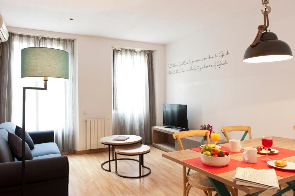 a living room with a table and a couch at MH Apartments Ramblas in Barcelona