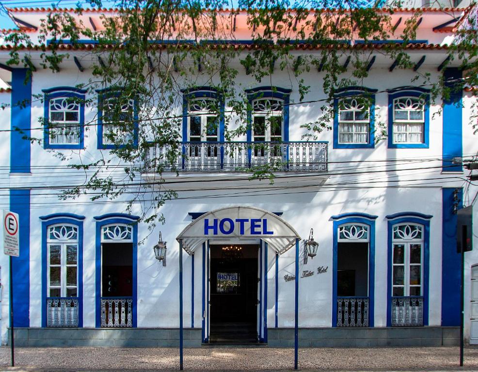 a hotel with a blue and white building at Vitória Palace Hotel in Lavras